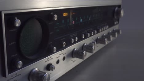 switching on-off old retro amplifier, with wooden edges and aluminium knobs