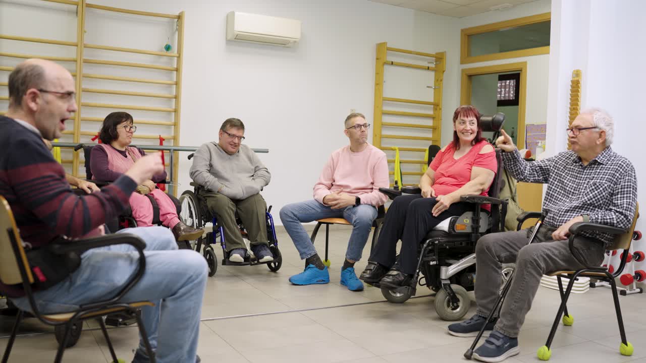 Group therapy session with people in wheelchairs