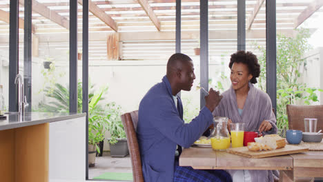 Video-of-happy-african-american-couple-eating-breakfast-together