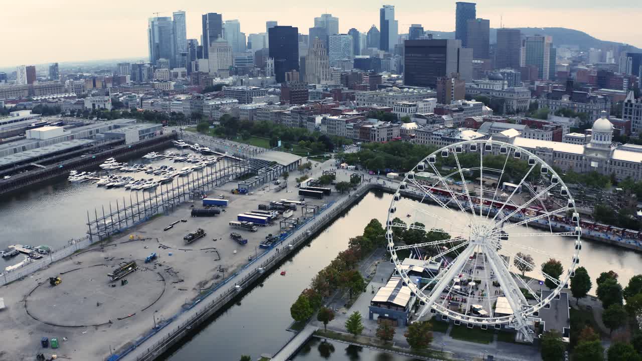 Aerial shot of Montreal's Old Port with the Ferris wheel in view, showcasing the vibrant waterfront and historic architecture. Perfect for capturing the essence of the city.