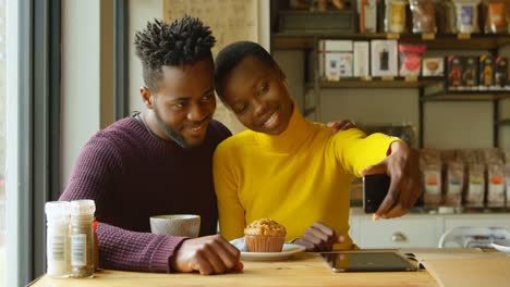 couple taking selfie in cafe 4k