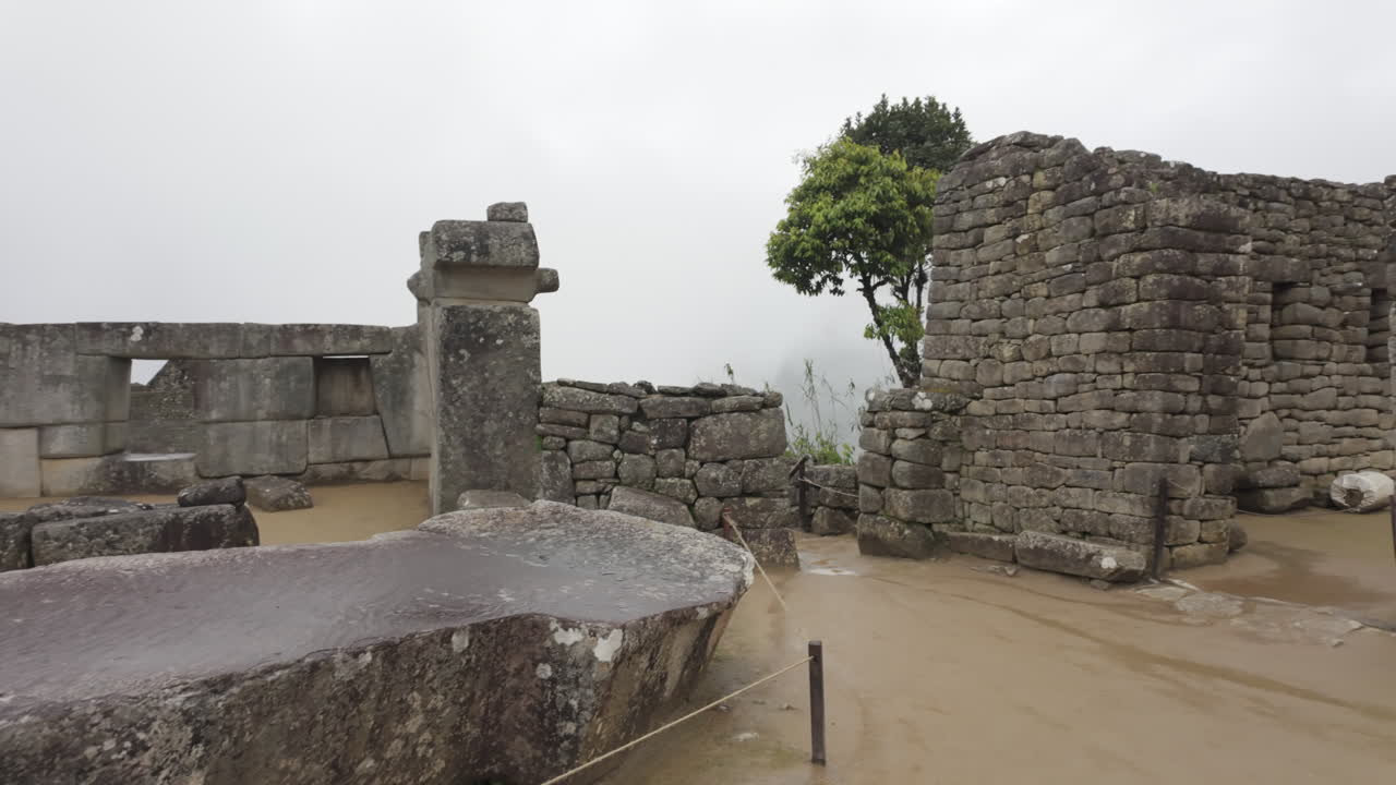Slow motion video of Inca stone structures inside Machu Picchu, showing ancient walls and architecture in Peru
