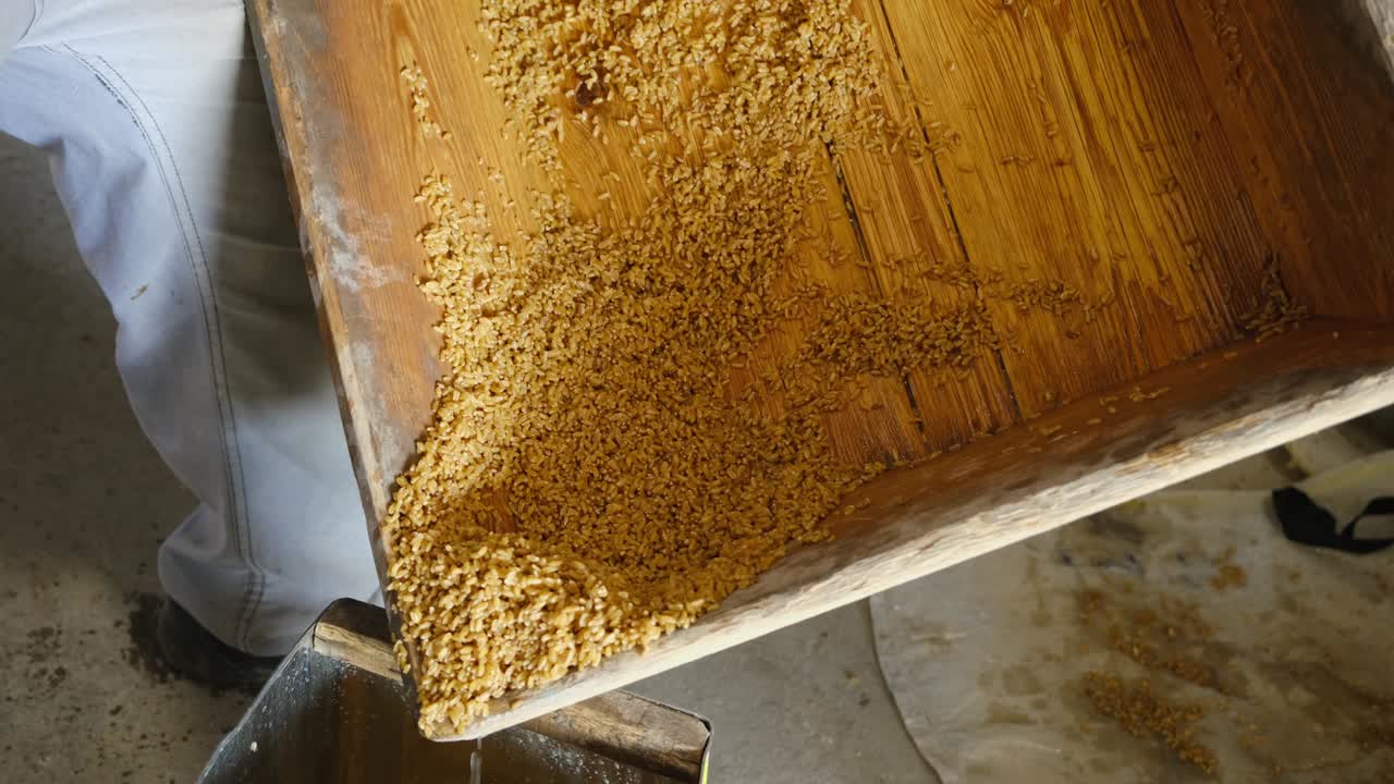 los granos de trigo se empapan en un cubo de madera y se preparan para convertirse en bulgur utilizado en el arroz bulgur, un alimento turco.