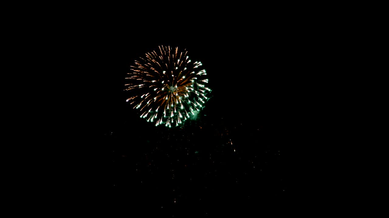 Celebration firework exploding and glow over dark background with dark and grain processed