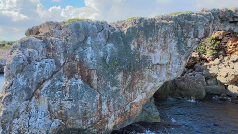 discover the natural beauty of cala varques, featuring a breathtaking rock arch surrounded by clear blue waters and rugged cliffs. this serene location is perfect for nature lovers.