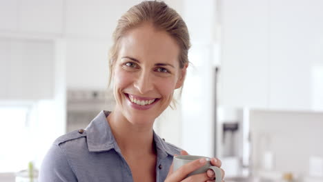 Woman-drinking-coffee-and-smiling-at-camera-in-close-up-slow-motion-portrait