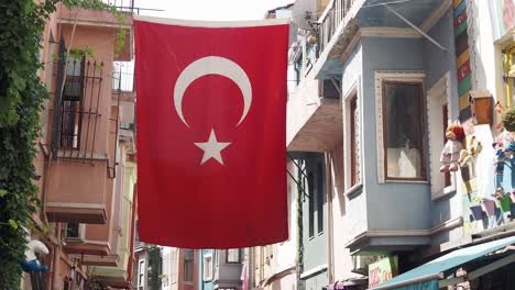 turkish flag hanging in a narrow alleyway