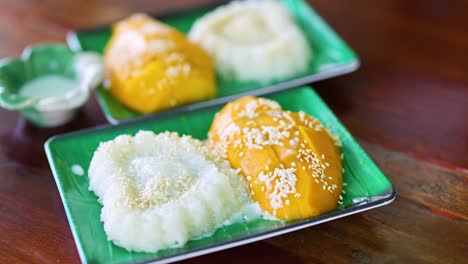 hand serving traditional thai dessert on a plate