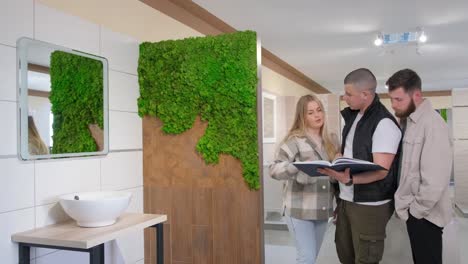 a group admires interior design on a tablet in buildings bathroom