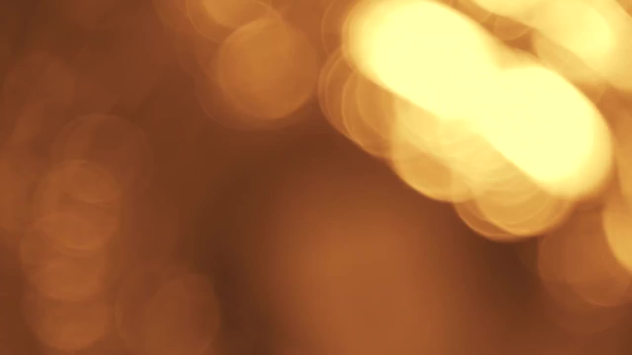 Efeito Bokeh de Luz Dourada Abstrata em Fundo Escuro