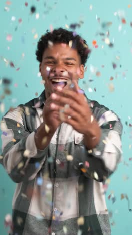 cheerful man celebrating big win showered in confetti