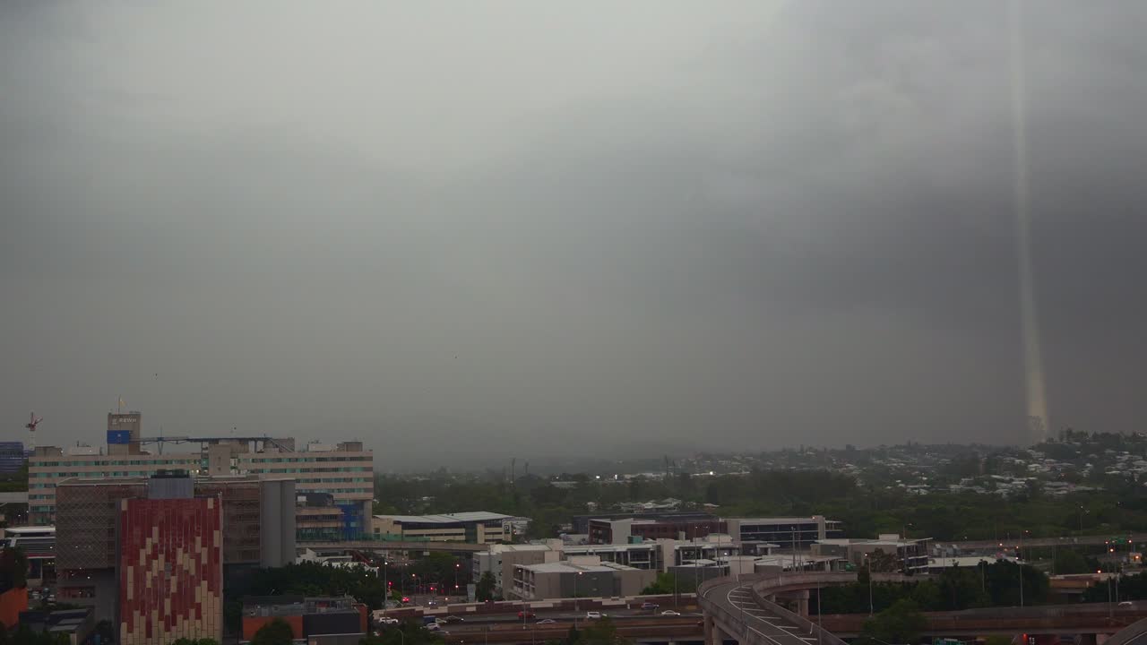A wild storm clouds loom over Brisbane, unleashing lightning strikes and intense thunderstorms across Southeast Queensland