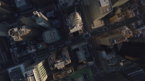 Aerial-birds-eye-overhead-top-down-panning-view-of-high-rise-buildings-in-city.-Fly-above-Chrysler-Building-with-tall-spire.-Manhattan,-New-York-City,-USA