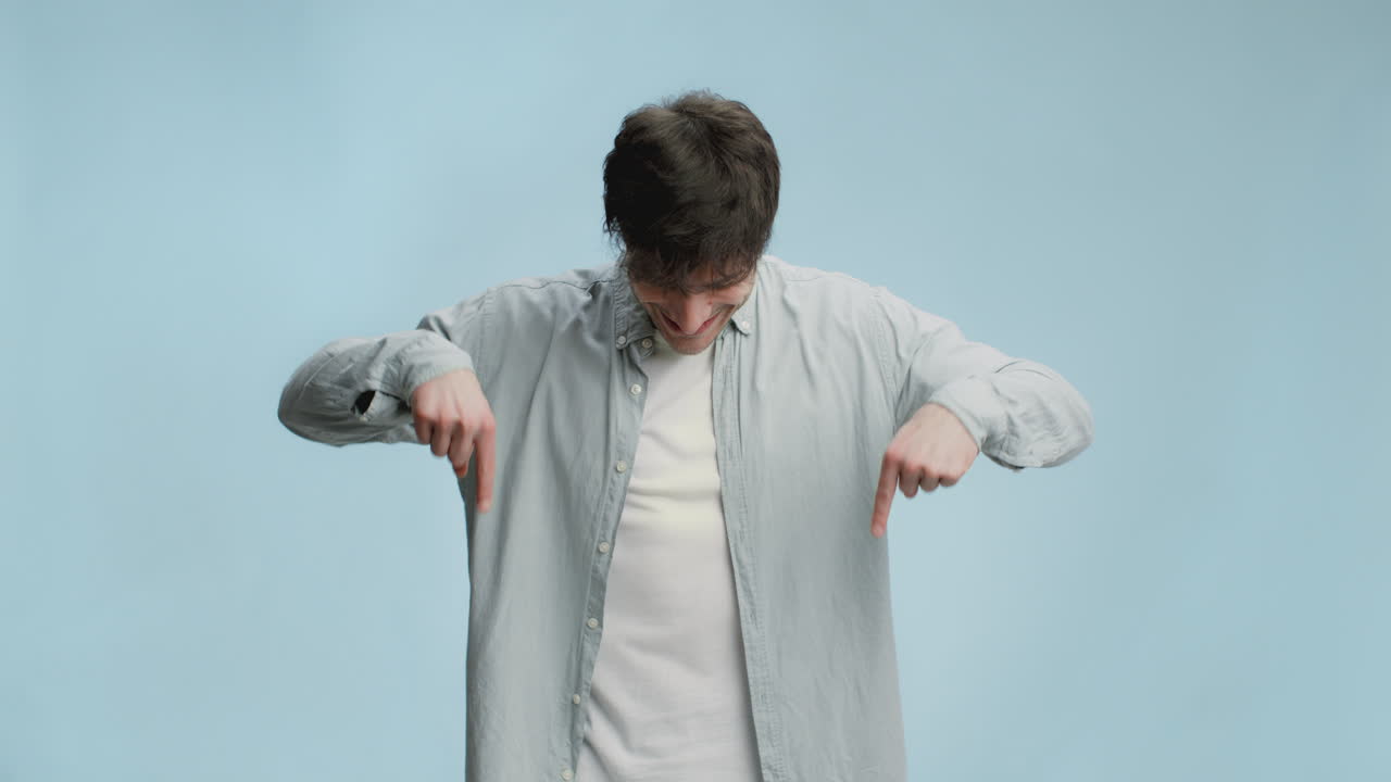 Man Pointing Down with a Happy Expression