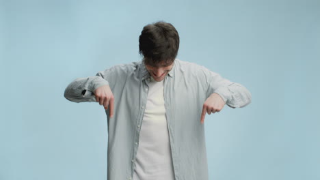man pointing down with a happy expression