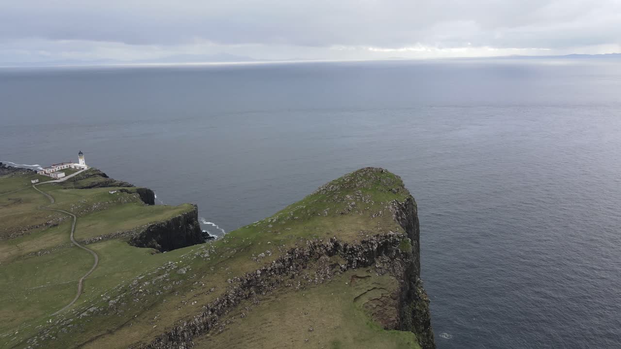 Aerial view of Neist Point encapsulating the untamed beauty of the Scottish coastline, where nature's forces have sculpted a rugged masterpiece that is both awe-inspiring and serene