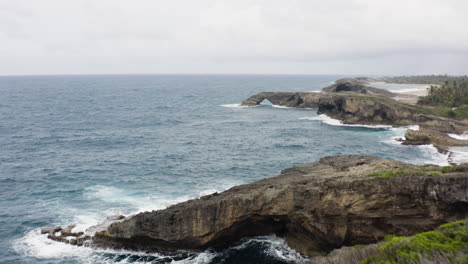 natural caves and idyllic ocean at cueva del indio in las piedras, puerto rico - aerial flyby