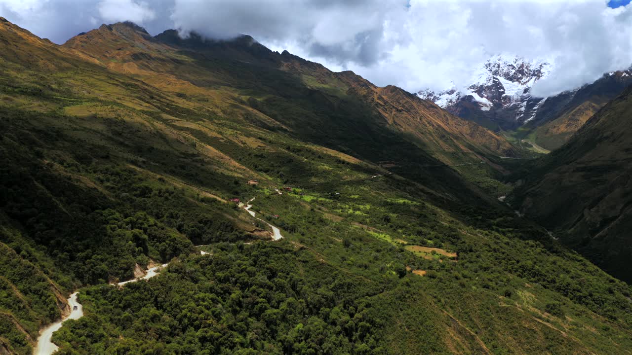Soray dirt road Mount Humantay Laguna Lake Sulcantay Trek Peruvian Andes Mountain Range Peru Perú aerial drone clouds blue skies high altitude elevation snow capped glacial peaks forward motion