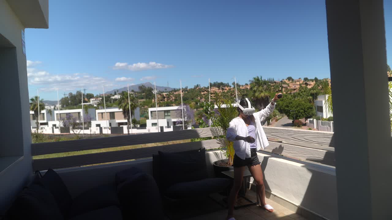 Woman enjoying virtual reality experience on a balcony