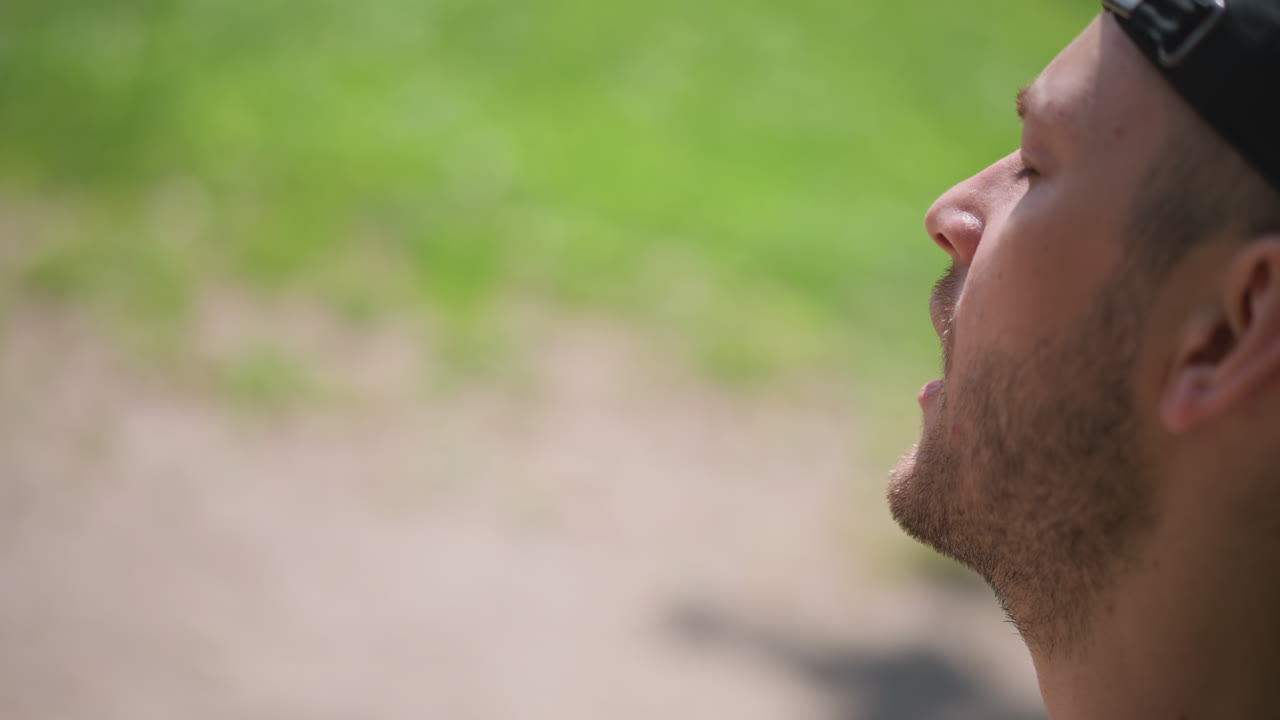 Man Drinks Water, Man Drinks Water After Physical Activity, Man Takes Long Sip From Clear Water Bottle Outdoors, Man Refreshes Himself With Strong Drink From Transparent Bottle In Park Park