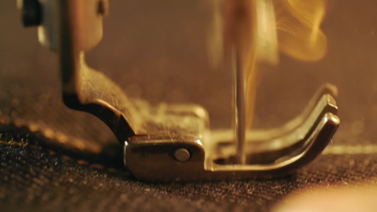 Close-up slow motion image of sewing machine at work