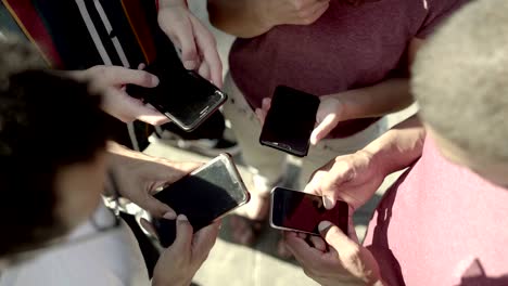 top view of young people using smartphones.