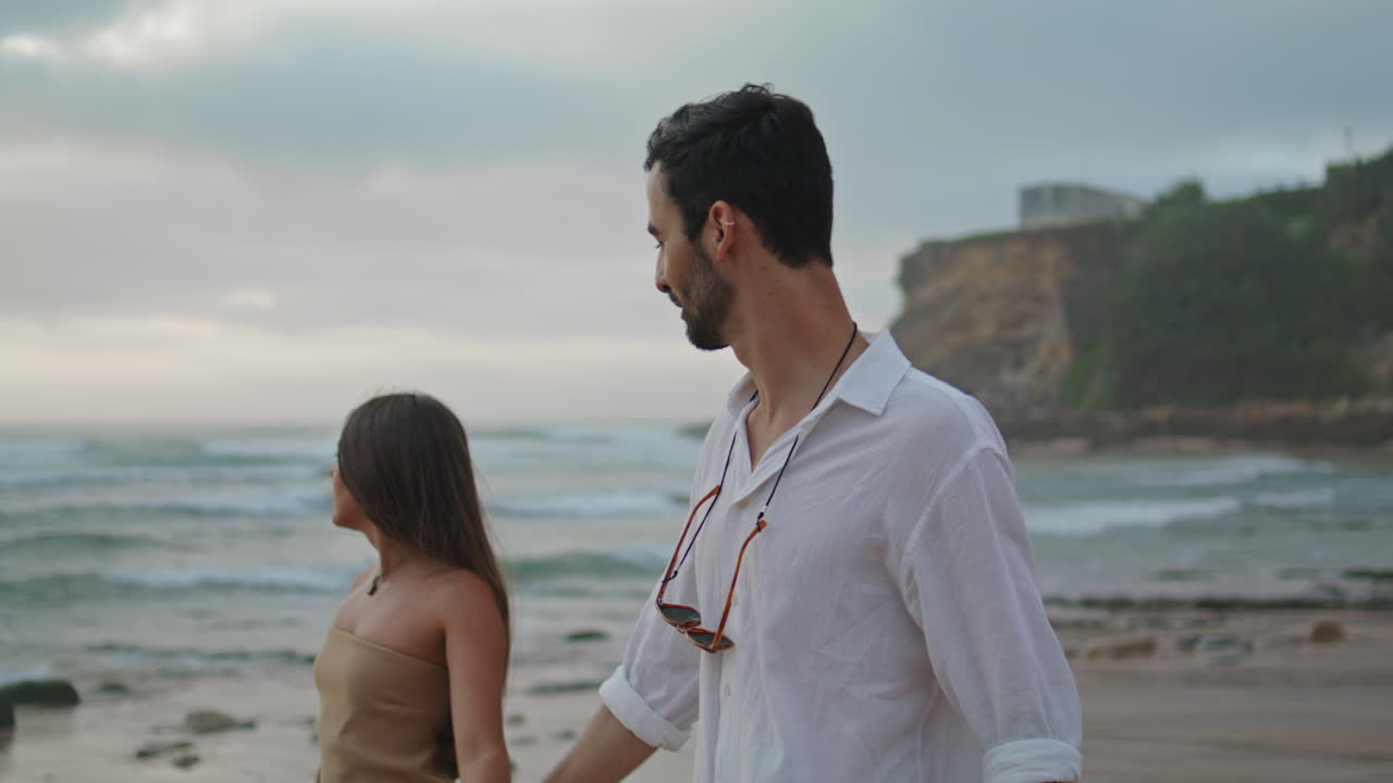 Carefree lovers walking on sandy beach closeup. Couple enjoying moment together