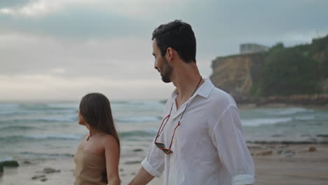 carefree lovers walking on sandy beach closeup. couple enjoying moment together