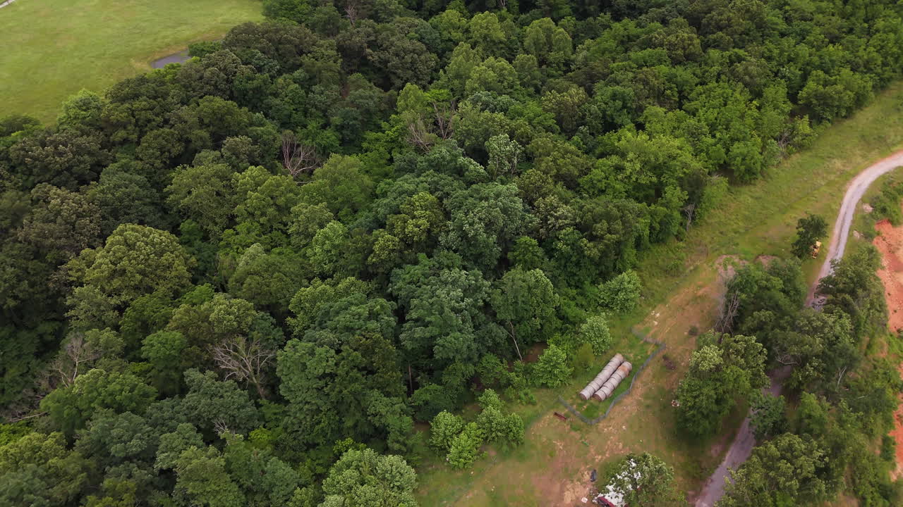 Aerial View Of Rural Landscape With Lush Green Trees And Dirt Road In Siloam Springs, Arkansas, United States - Drone Shot