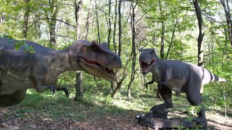 models of two dinosaurs in the middle of the forest in the dinosaur park models of two dinosaurs in the middle of the forest in the dinosaur park jurassic park