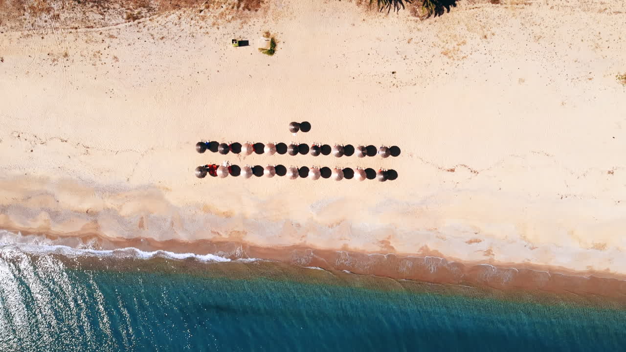 Asprovalta with multiple buildings and greenery, green hills on the background. Aegean sea coast. Long beach along the town. Sunny day. Greece