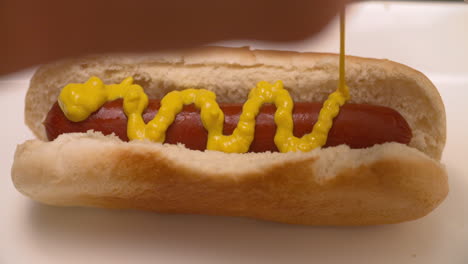 Squirting-mustard-onto-a-hot-dog