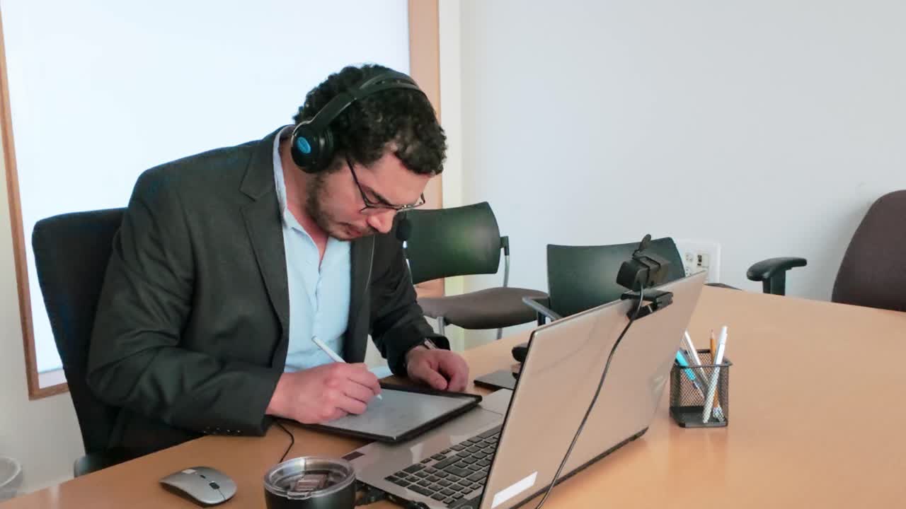 Man Reviewing Project Details on Tablet