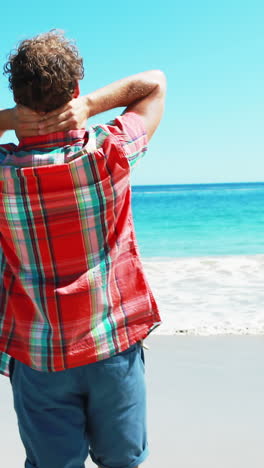 excited man standing with arms out stretched