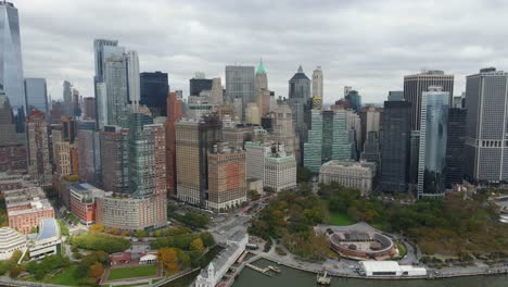 aerial view of skyscrapers in lower manhattan, in cloudy nyc - tracking, drone shot