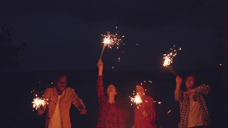 friends having fun at night around a campfire