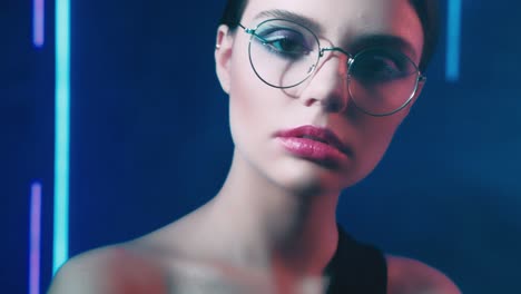 neon light portrait confident girl eyeglasses blue