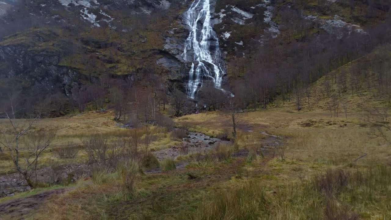 Upwards tilt to reveal majestic Steall Falls in late winter - Nevis Gorge, Scotland