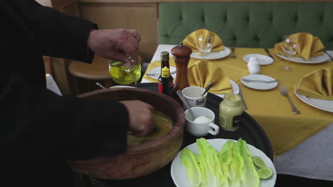 chef preparing a caesar salad in a restaurantc