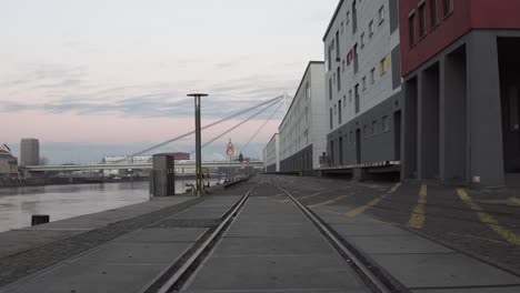 Tram-tracks-along-the-river-on-a-quiet-morning-in-Mannheim,-Germany