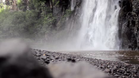 Close-up-shot-of-Cascade-Niagara-fall,-in-a-rocky-environment,-low-angle-shot,-rock-foreground