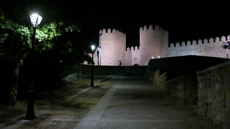 avila's old town at night, featuring the glowing, unesco-designated medieval walls.