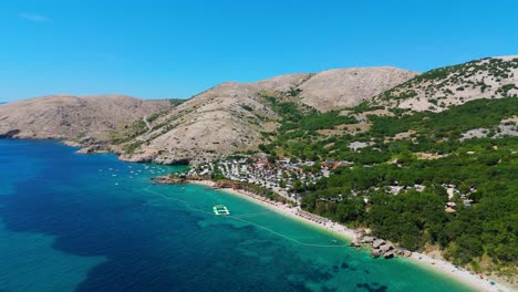 campsite at campig skrila, krk island, stara baska croatia, aerial view of the mountains and coast with boats, beaches and adriatic sea. the seaside rv campmobiles on a summer beautiful coastline