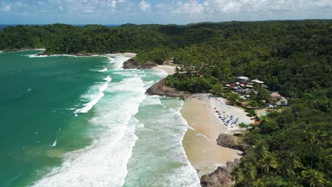 aerial view of tropical beach with waves and people