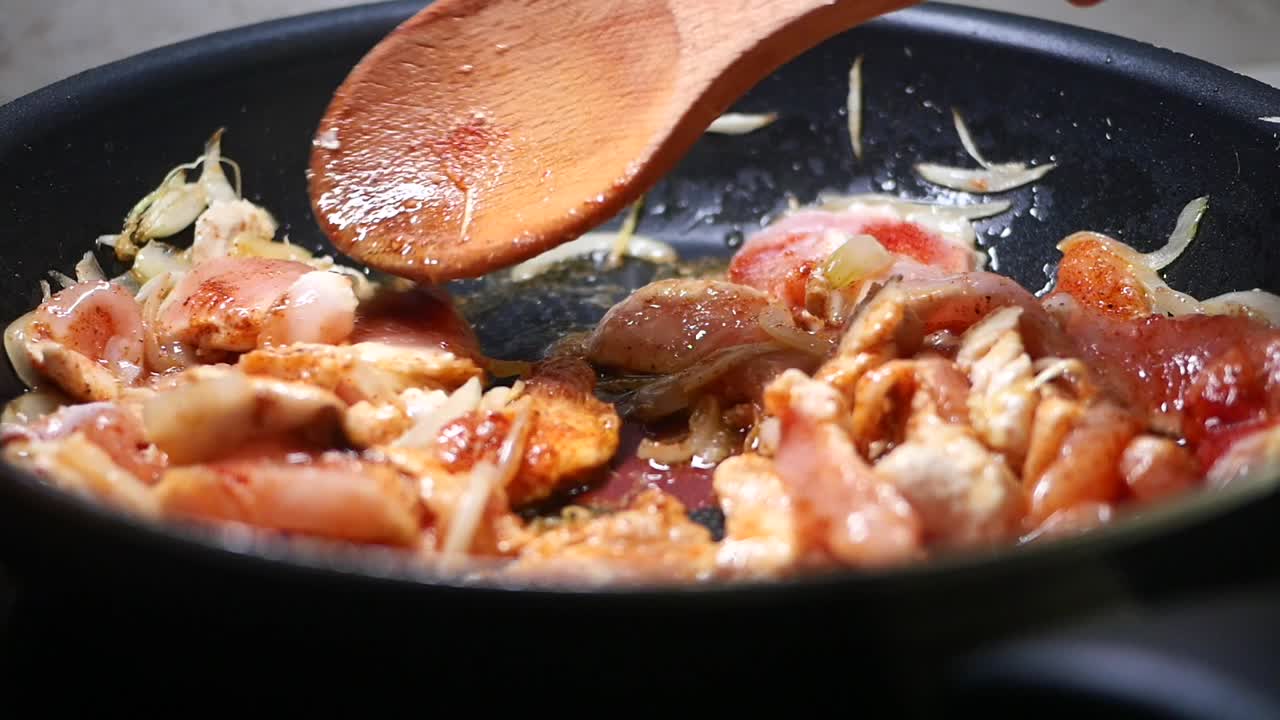 Close-up of chicken being cooked in a pan