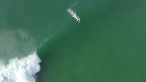 bodyboarder wearing yellow lycra catching a wave and doing some manoeuvres