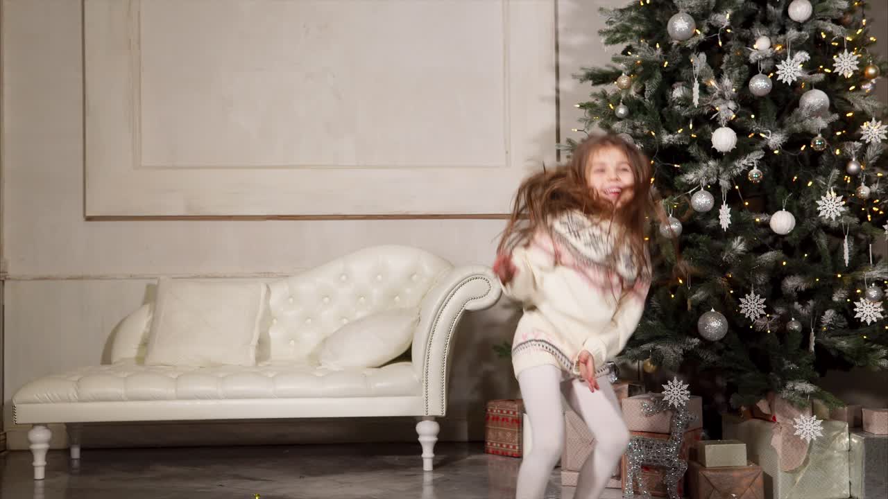Happy Girl Jumping near Christmas Tree