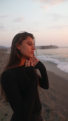 woman praying at the beach sunset