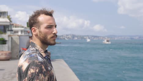 Thoughtful-man-watching-the-ships-in-the-sea.