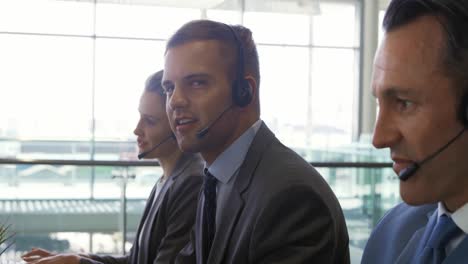 Business-people-wearing-headsets-in-a-modern-office